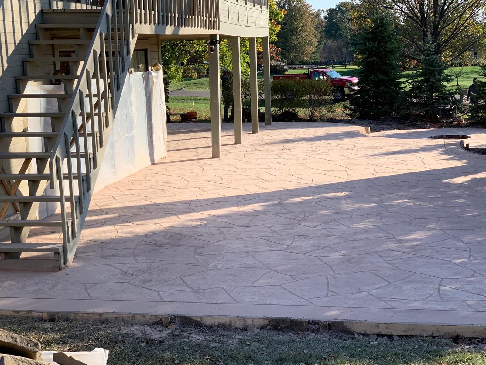 Backyard concrete patio with steps