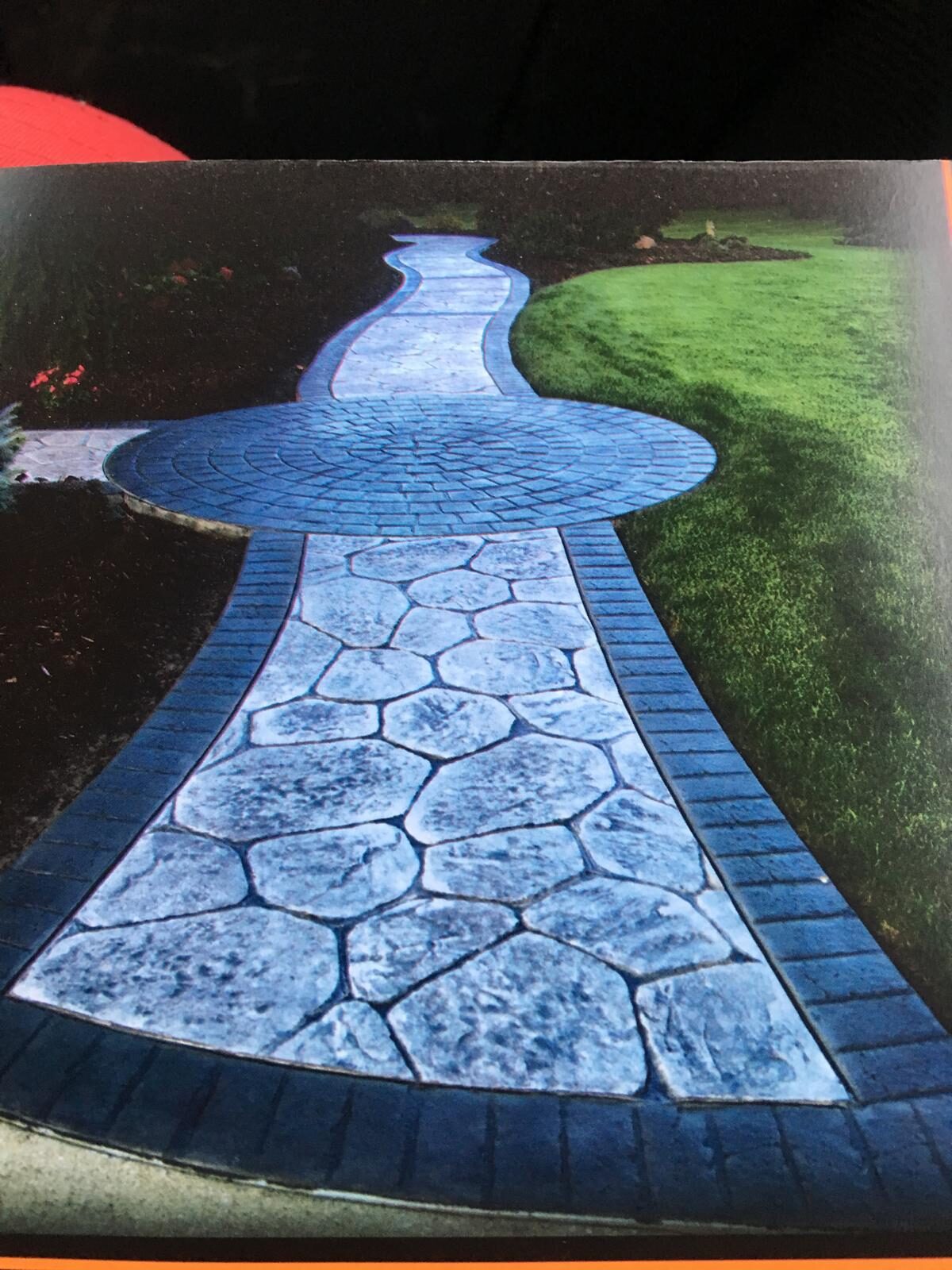 Stamped stone walkway through a lawn